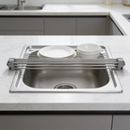 Empty rolled stainless drying rack resting across a kitchen sink