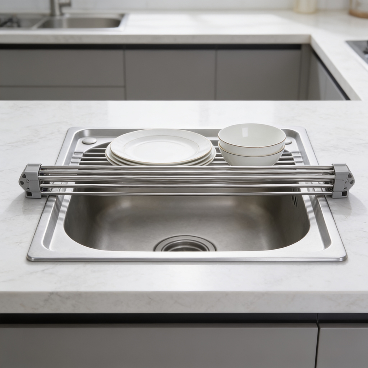 Empty rolled stainless drying rack resting across a kitchen sink