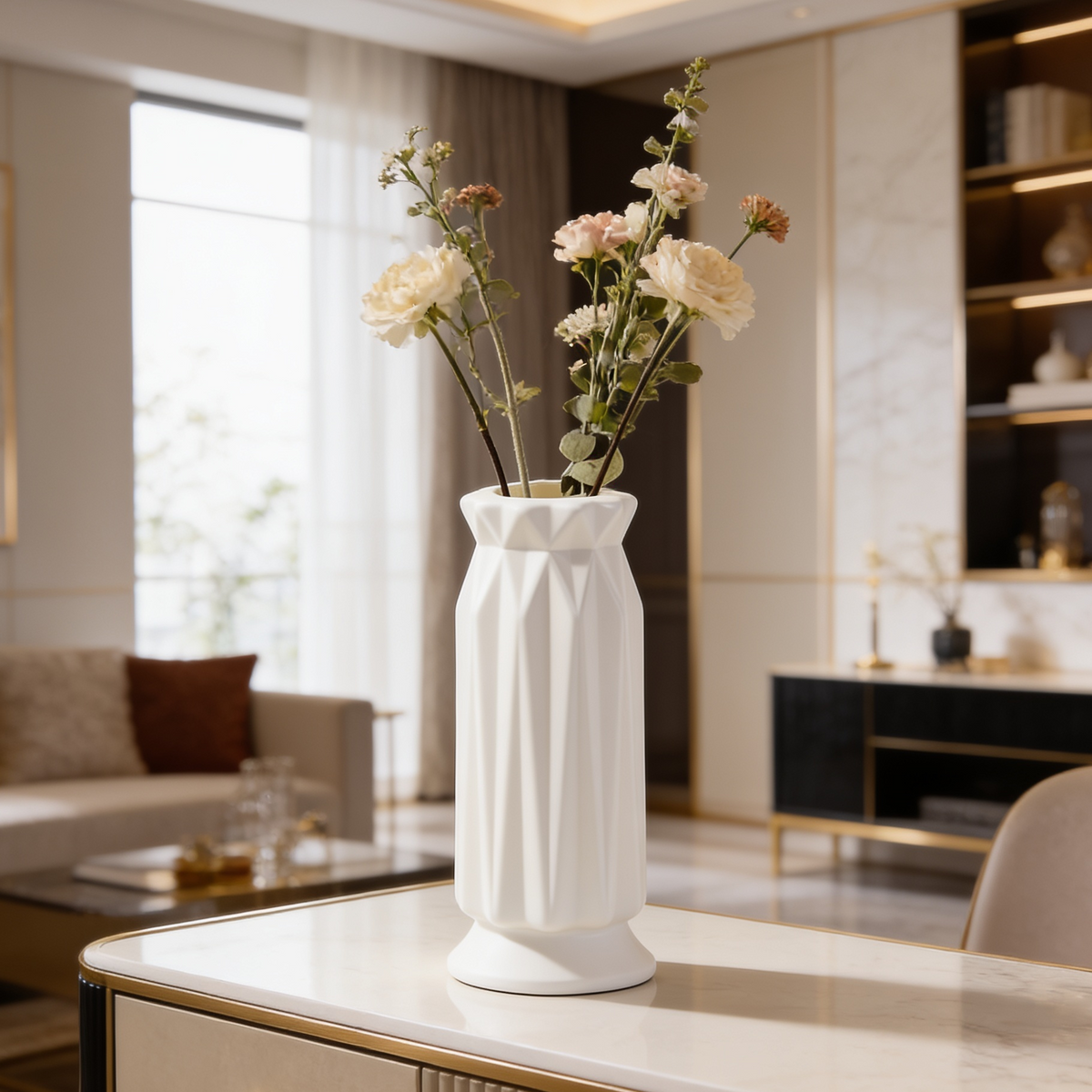 White faceted vase of roses on a console beside a bright window