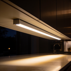 Warm light bar fixed under a cabinet lighting a dark countertop at night