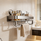 Shelf and towel rail fixed beside a lit mirror above a dark wood vanity