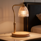Warmer lamp with an empty wood base on a table in front of a framed print
