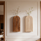 Brown and beige arched wall vases mounted together on a paneled wall