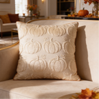 Cream pillow cover quilted with raised pumpkin outlines amid autumn decor