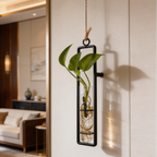 Black framed tube with a heart leaf cutting on a paneled wall