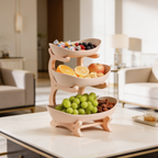 Three tier white serving stand of fruit on a wooden frame in a bright dining room