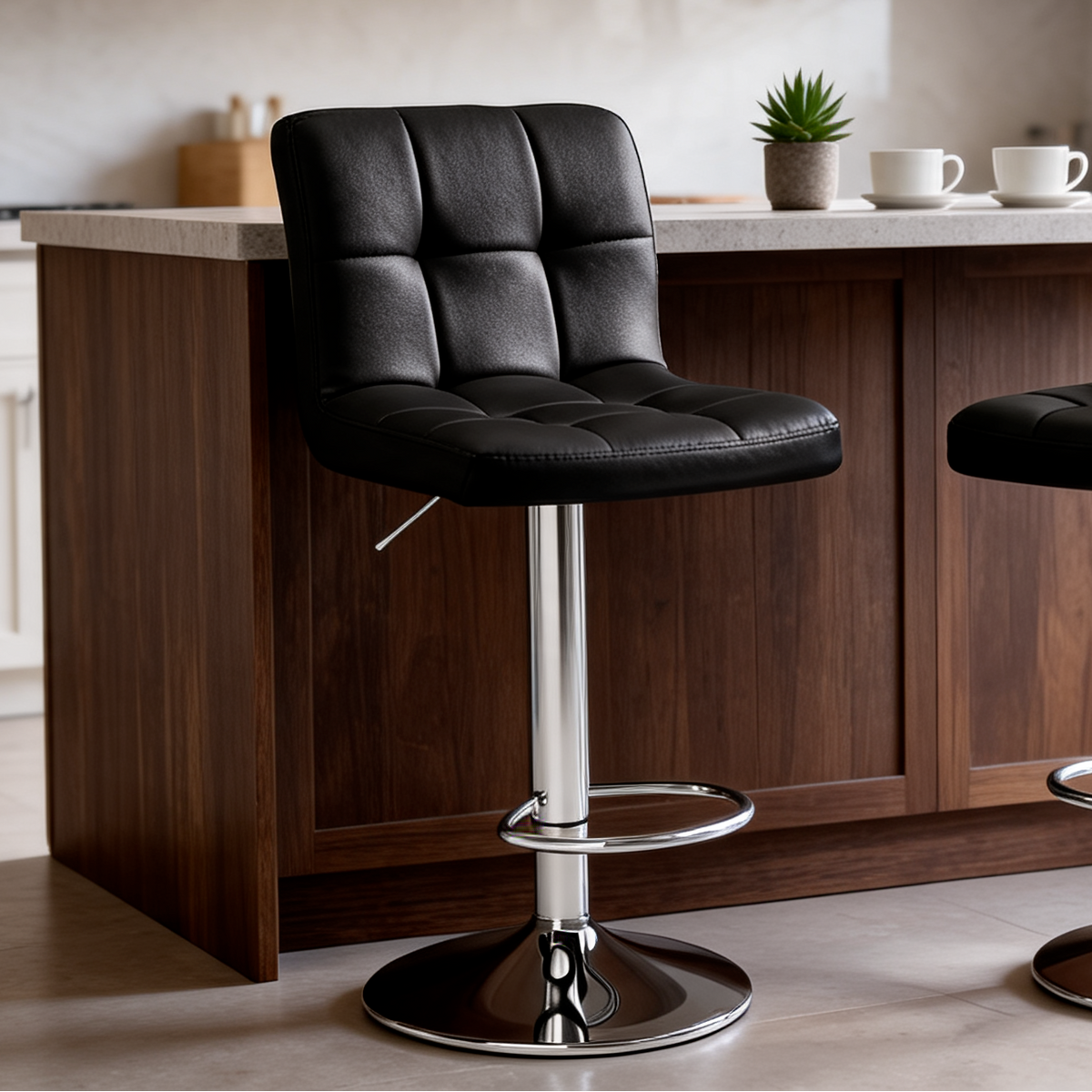 Close view of a single black tufted stool with its chrome footrest at a kitchen island