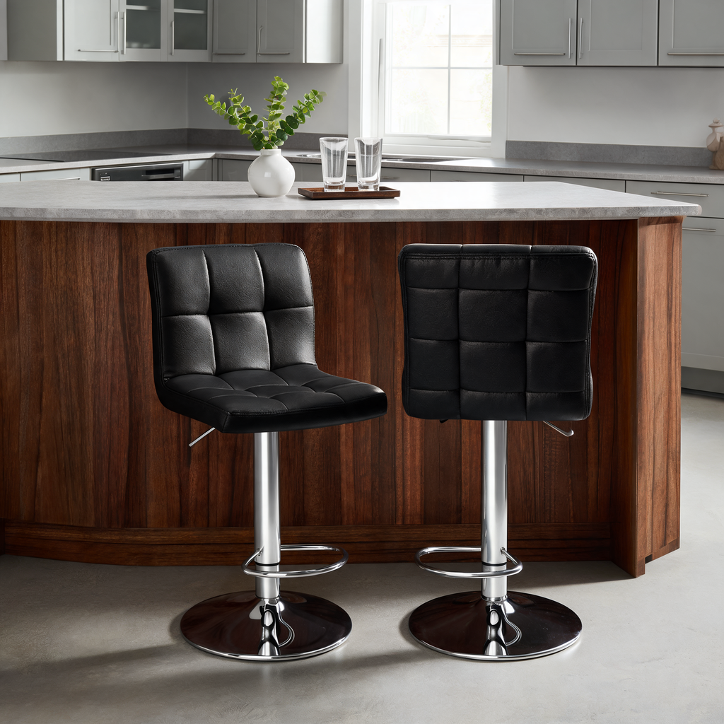Pair of black square stitched stools at a curved dark wood island in a gray kitchen