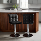 Pair of black square stitched stools at a curved dark wood island in a gray kitchen
