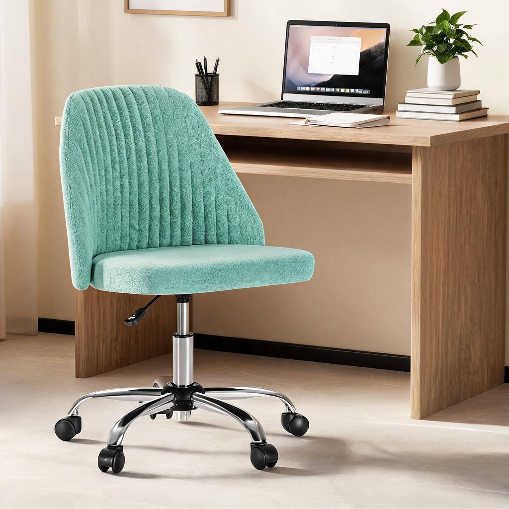 Mint green ribbed swivel chair at a wooden desk with a laptop and a leafy plant