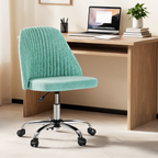 Mint green ribbed swivel chair at a wooden desk with a laptop and a leafy plant