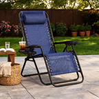 Navy zero gravity recliner on a patio with a mug and book on the side tray beside a woven table