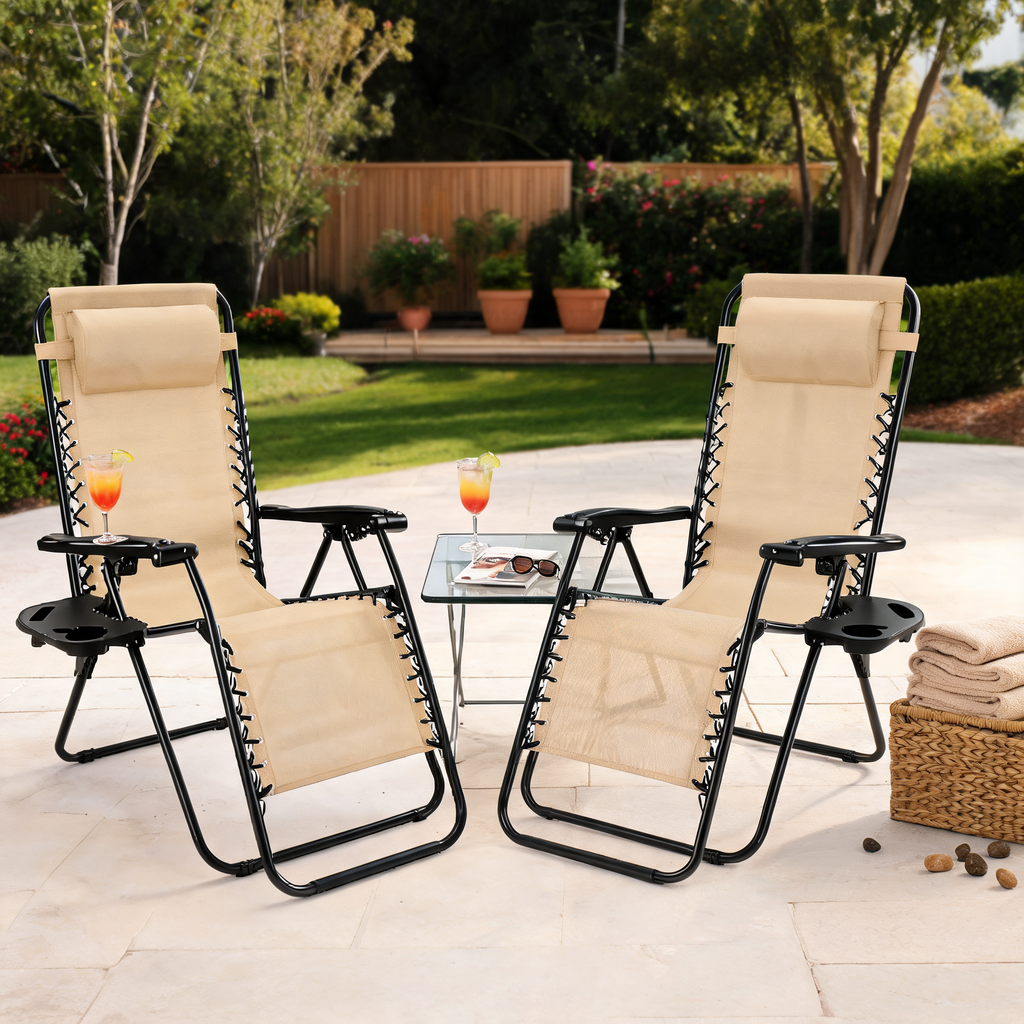 Pair of beige zero gravity recliners with headrests and a side table on a patio
