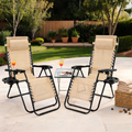 Pair of beige zero gravity recliners with headrests and a side table on a patio