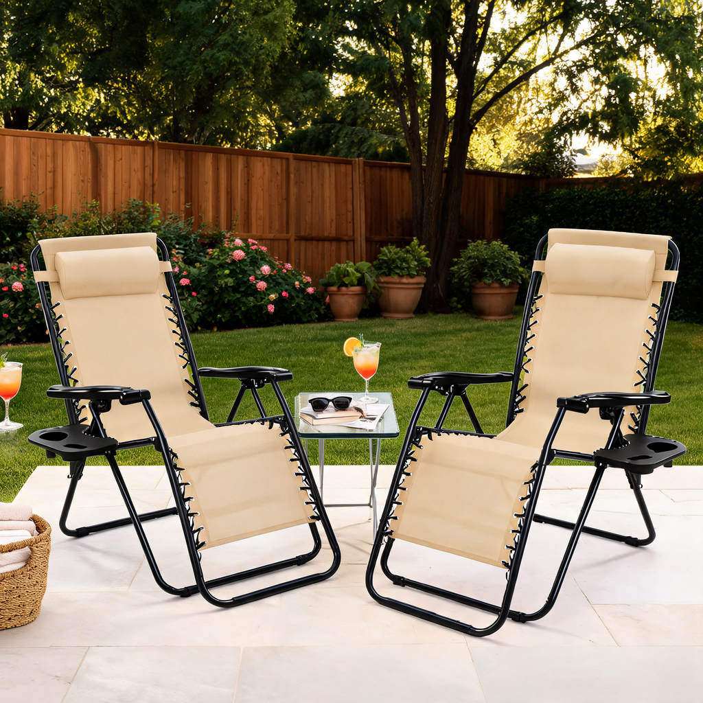Two beige zero gravity loungers with cup trays in a fenced backyard with roses