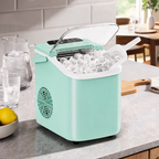 Mint green ice machine full of ice on a marble counter next to a water pitcher and a lemon