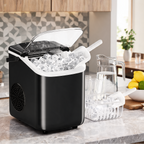 Black countertop ice machine with the lid open, shown beside a pitcher of ice water and a drying tray