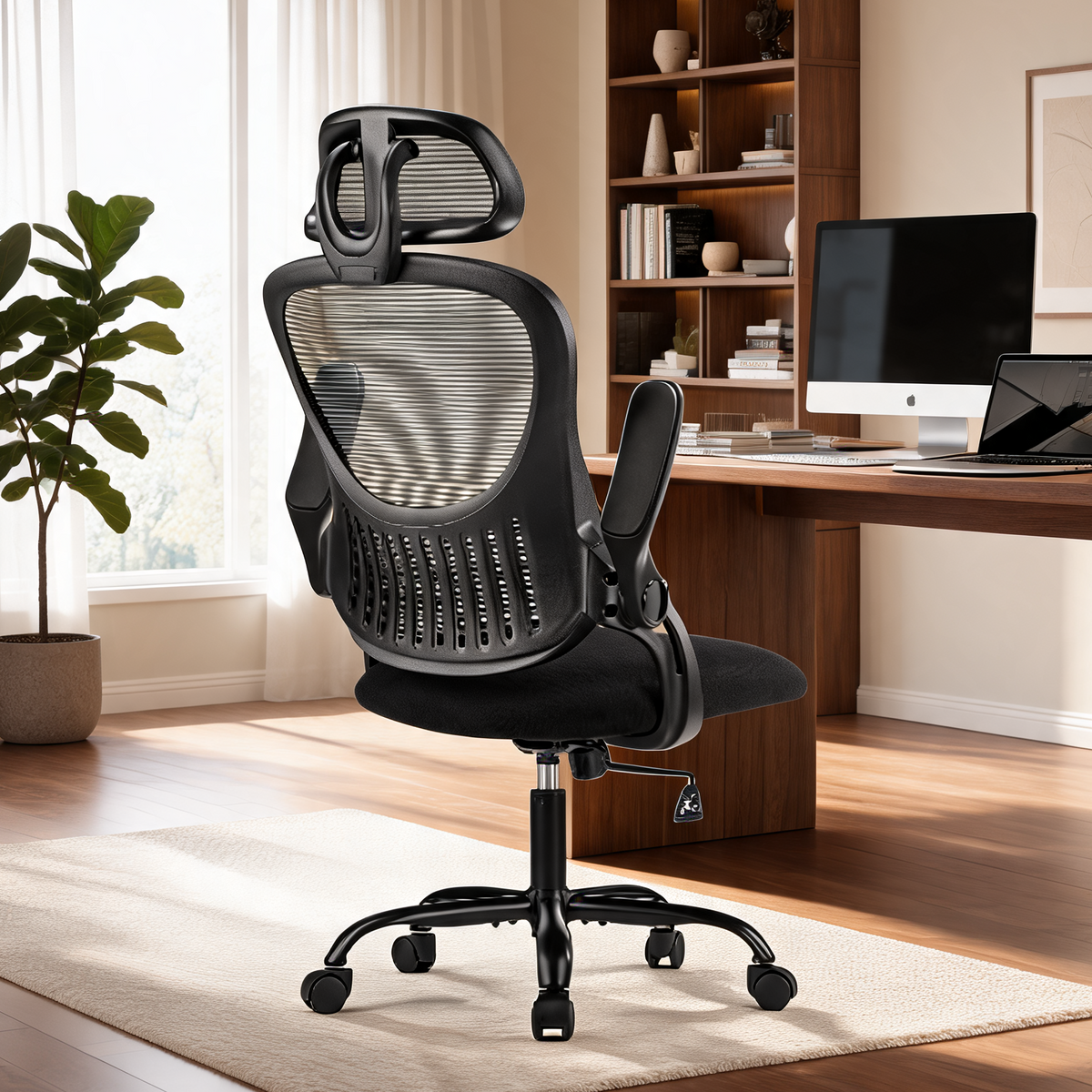 Black mesh high back chair with a headrest turned toward a wooden desk beside a tall plant