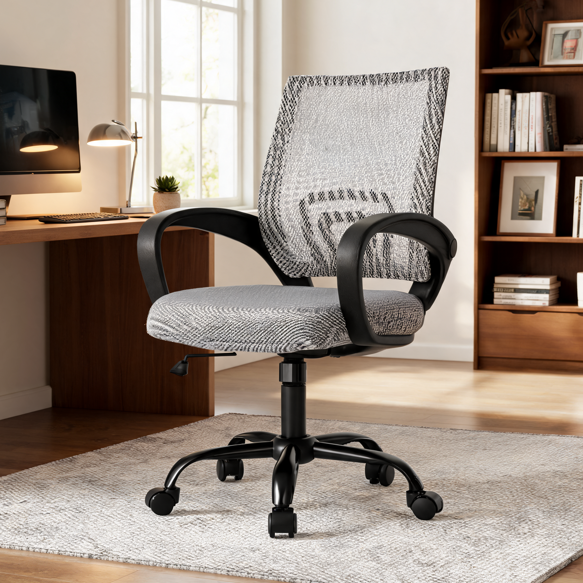 Gray mesh back office chair in a home office with a wooden bookcase
