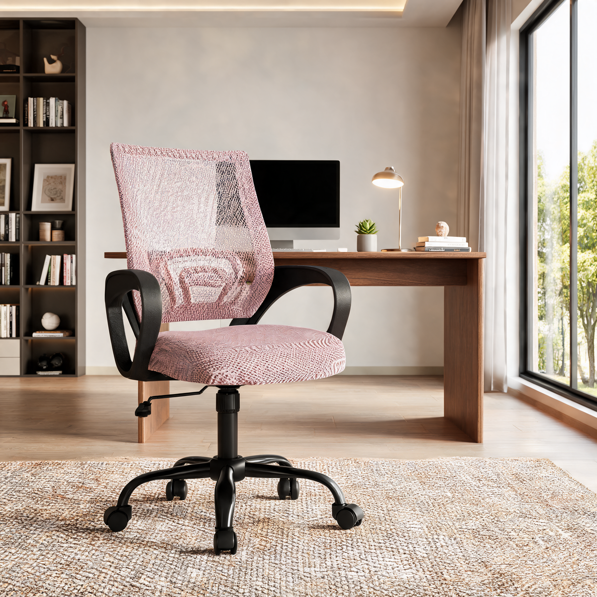 Pink mesh back office chair beside a desk holding a laptop by a tall window
