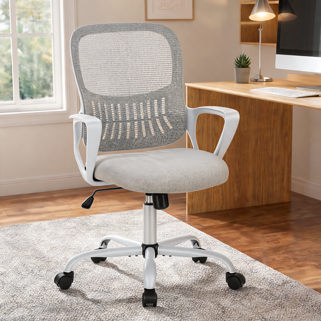 Gray mesh back office chair with white frame and loop arms beside a wooden home office desk