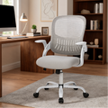 Gray mesh chair with a padded seat parked next to a dark wood bookcase and desk