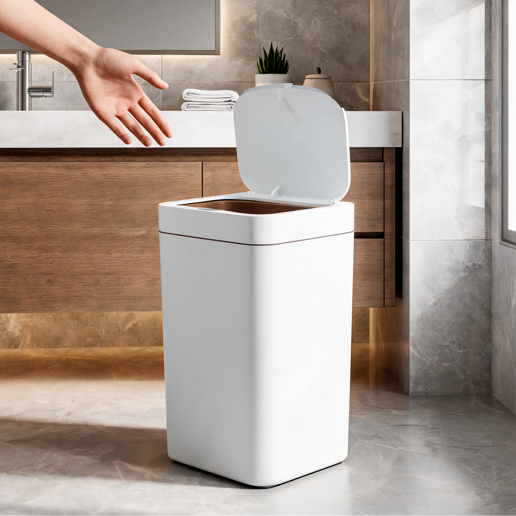 Hand reaching toward the open sensor trash can beside a stone bathroom counter