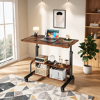 Brown rolling desk with a laptop and lamp on a patterned rug beside a plant