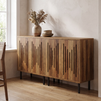 Two rustic brown slatted door cabinets pushed together against a pale wall on slim black legs, dried grasses on top.