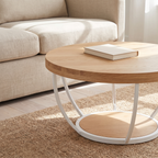 Round oak top coffee table on a white curved steel arc base with a solid round lower shelf, beside a linen sofa.